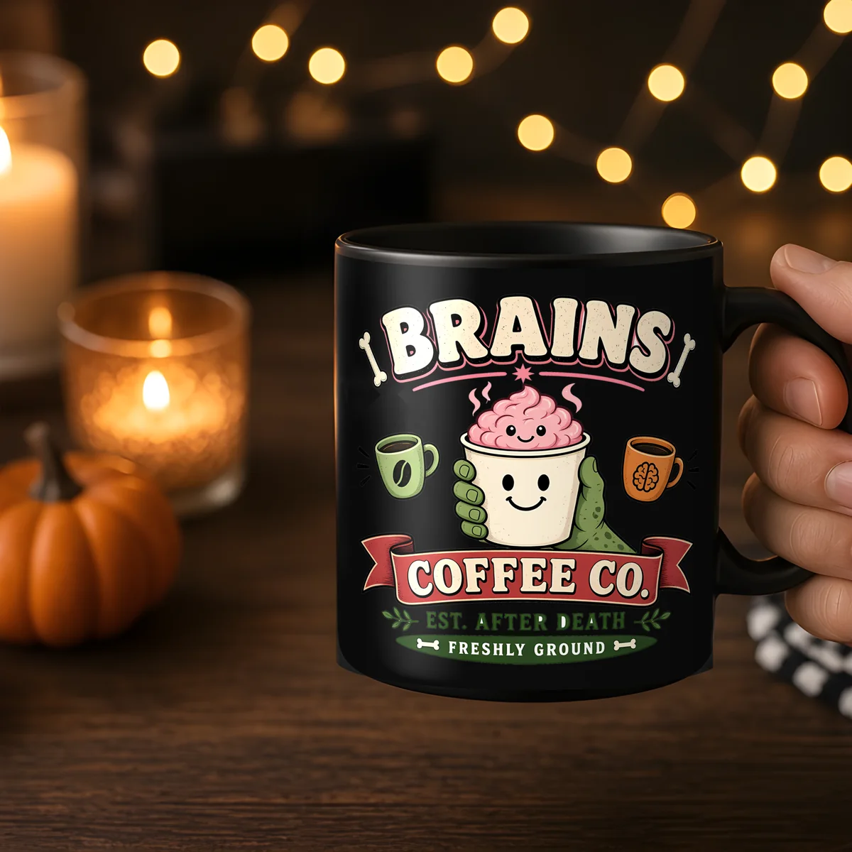 Brains Coffee Co. Mug held by the handle on a cozy Halloween desk with candles and a small pumpkin